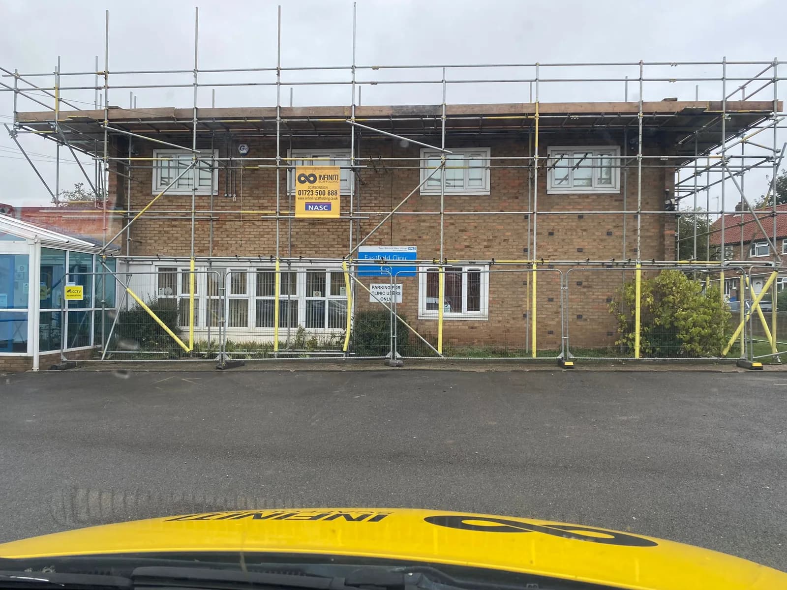 Eastfield Clinic Scarborough with scaffold access installed for NHS flat roof waterproofing works using a Triflex liquid-applied system.