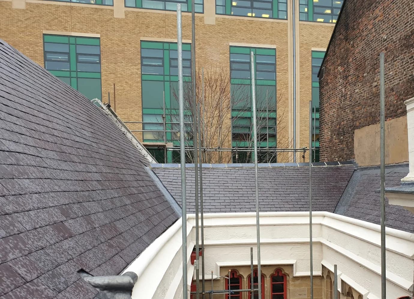 Completed Welsh slate roof at Trinity House on the Newcastle Quayside, with restored stonework and heritage detailing after the listed-building refurbishment.
