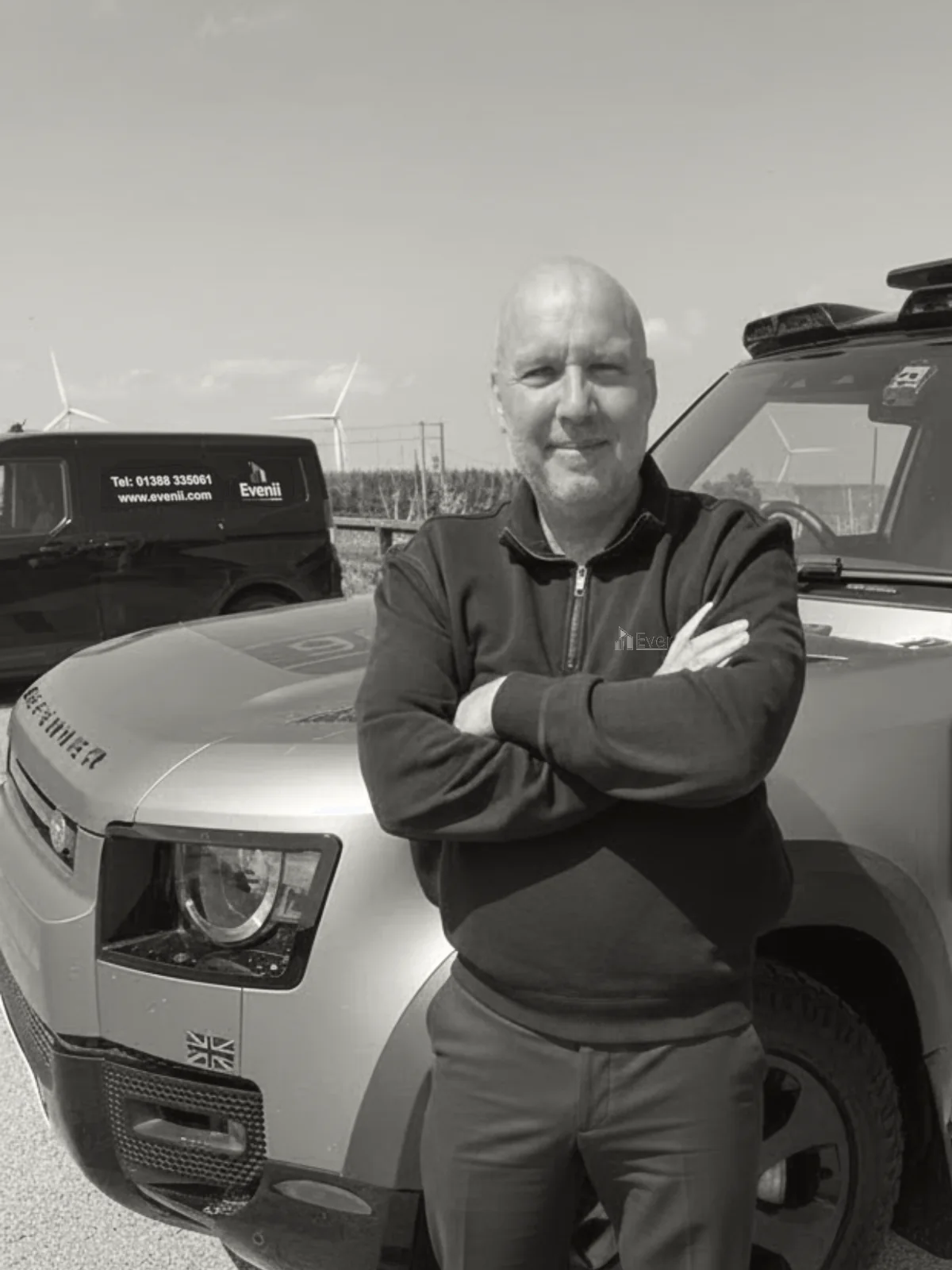 Dean Goyns, operational lead at Evenii, beside a branded Evenii Land Rover Defender