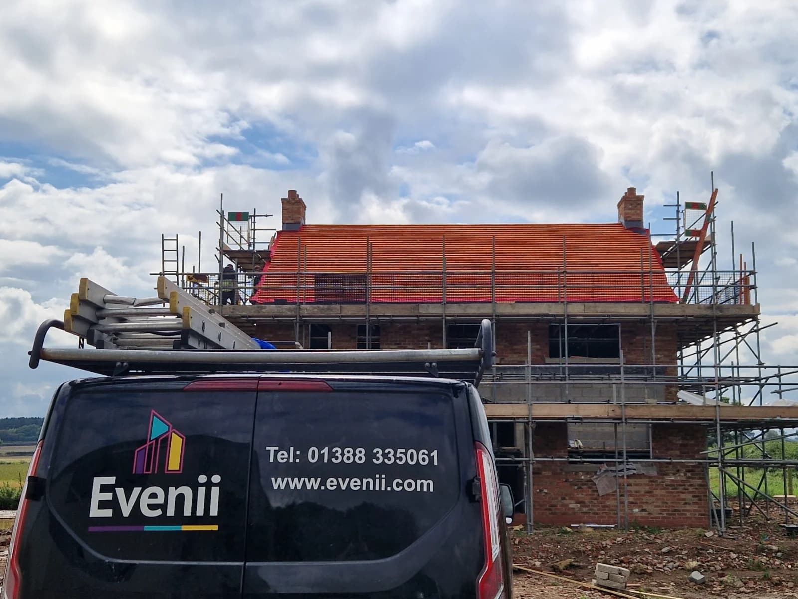 Evenii branded van with phone number 01388 335061 and URL evenii.com visible — parked at a completed new-build with scaffold still in place